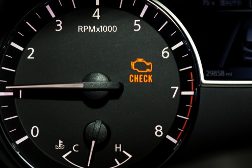 Check Engine Light diagnostics and repair in Kenner, LA at CAMS Automotive. Image of check engine light illuminated on car dashboard.