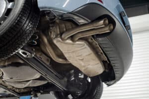 Loud exhaust system, auto repair in Kenner, LA by CAMS Automotive. Image of a vehicle’s exhaust system and muffler assembly while lifted for inspection. Highlighting CAMS Automotive’s commitment to safe emissions, proper airflow, and reliable vehicle performance.