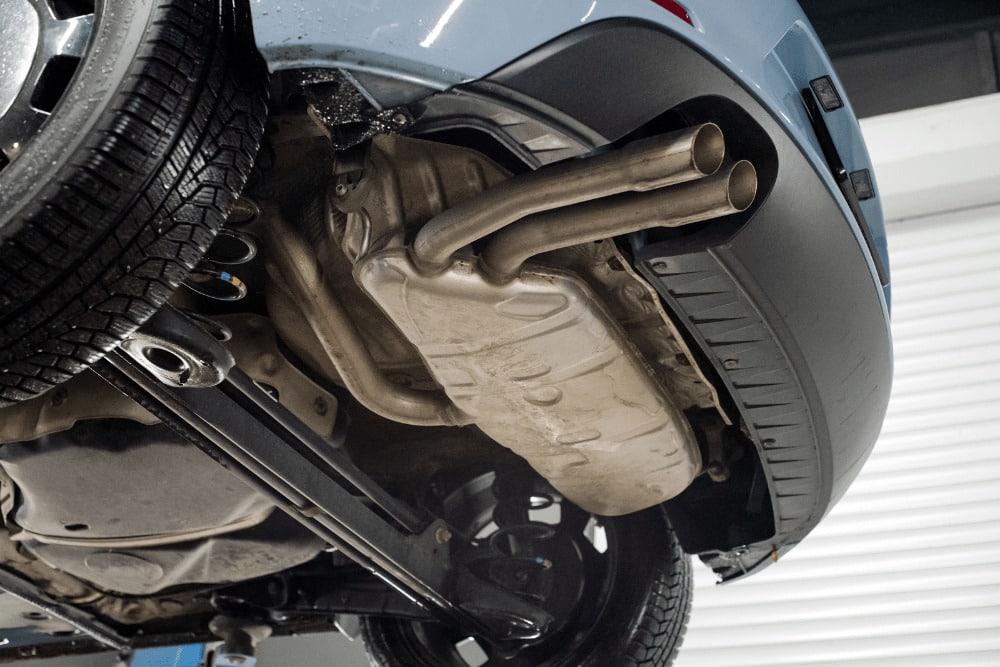 Loud exhaust system, auto repair in Kenner, LA by CAMS Automotive. Image of a vehicle’s exhaust system and muffler assembly while lifted for inspection. Highlighting CAMS Automotive’s commitment to safe emissions, proper airflow, and reliable vehicle performance.